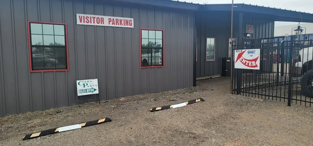The Cars and Parts sales office with visitor parking and the yard entrance